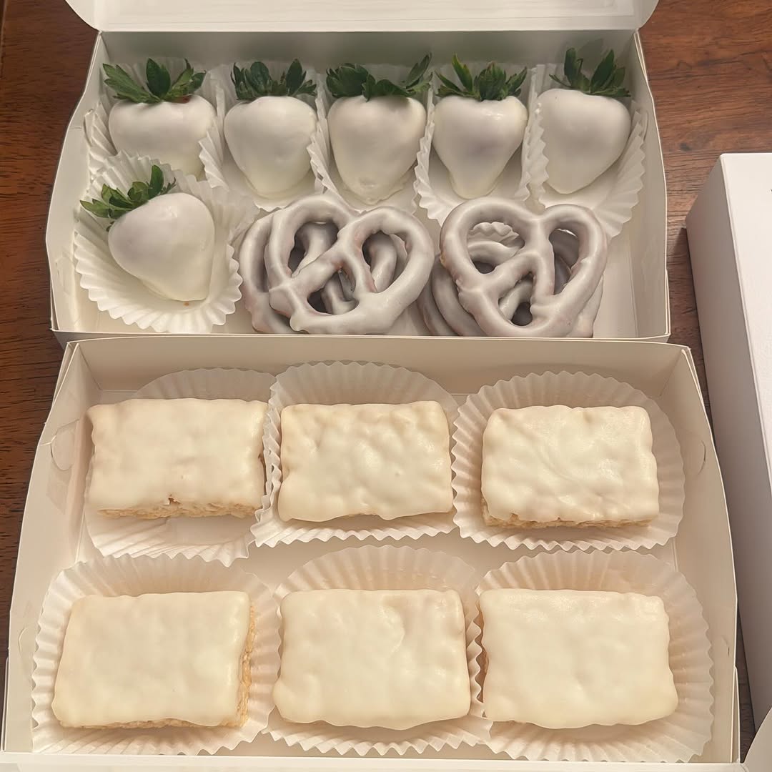 Elegant all-white chocolate assortment with six strawberries, three pretzels, and six Rice Krispie bars in a monochromatic minimalist presentation.