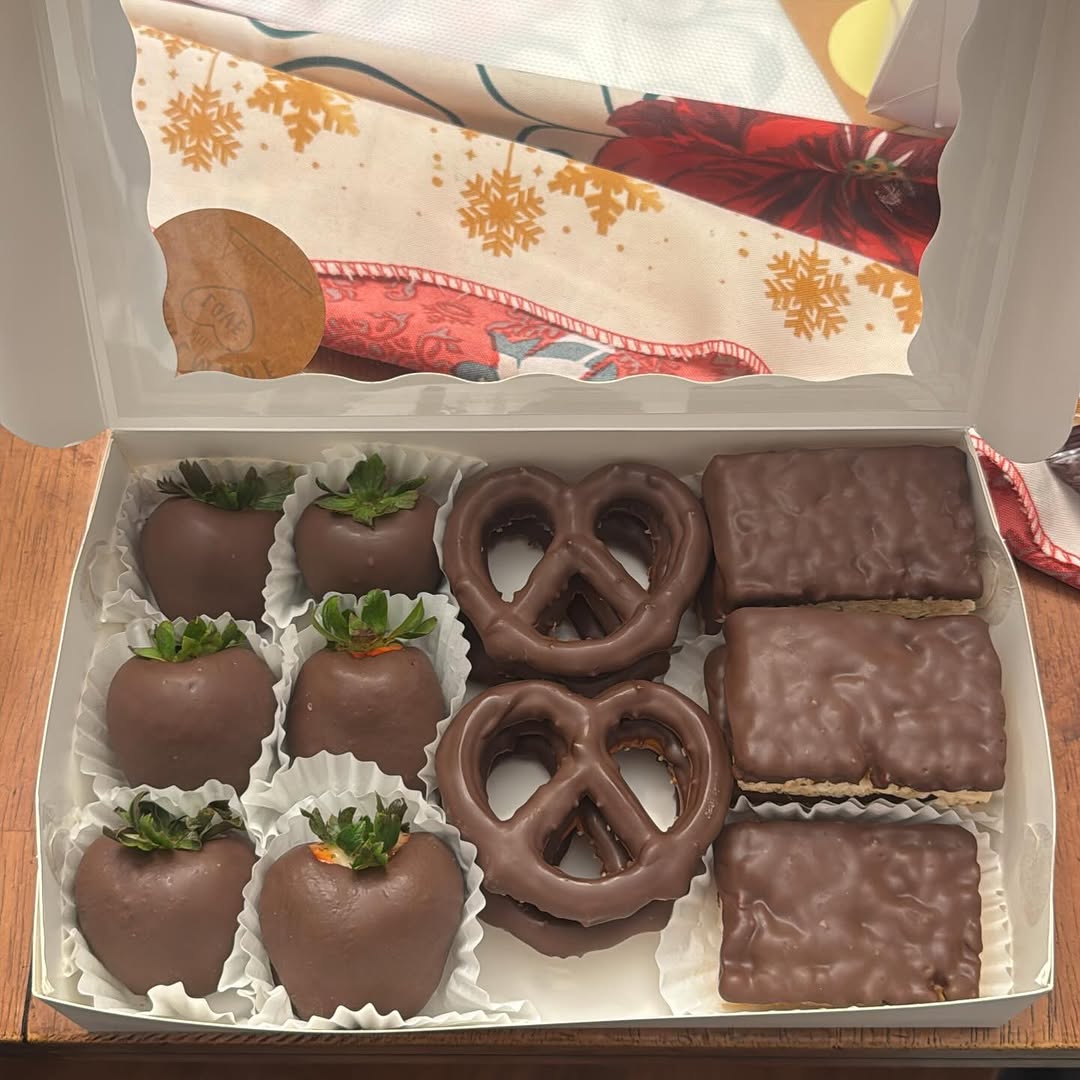 Holiday sampler box with six strawberries, two pretzels, and four Rice Krispie bars all in smooth milk chocolate coating.