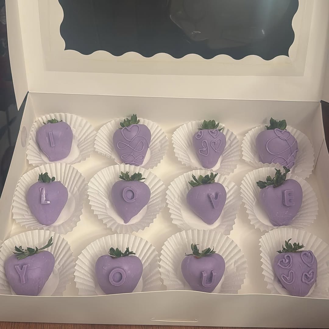A dozen lavender-coated strawberries with I LOVE YOU spelled in tone-on-tone purple letters and piped heart and swirl designs.